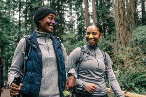 Two women going on a hike wearing Nozscreen on their noses